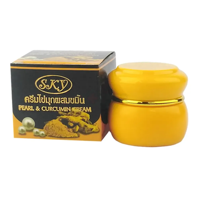 Yellow cream jar with gold lid and black box labeled 'SKY' on a white background