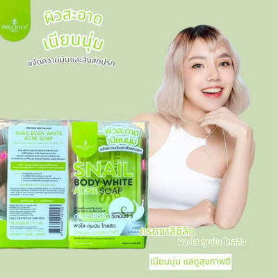 Woman holding Snail Body White Acne Soap packaging with a green background